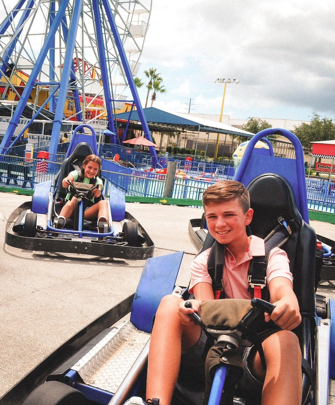 Two teenagers racing go-karts